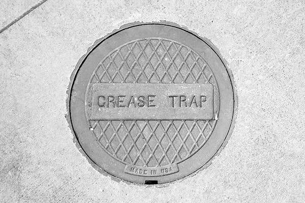 grease trap pumping involves the removal of accumulated grease and solids from the trap to prevent clogs and backups